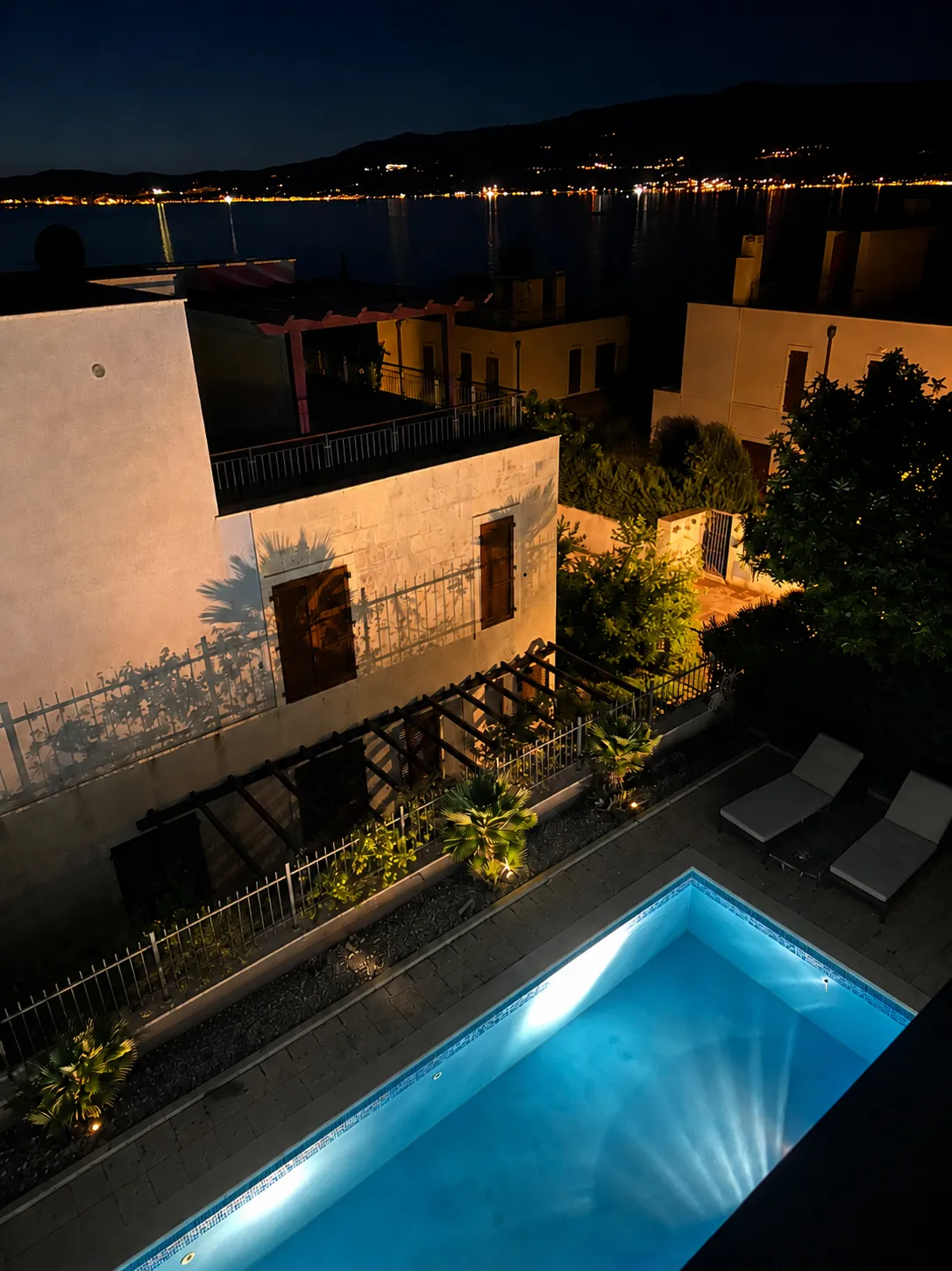 Pool at night with Adriatic lights in the distance