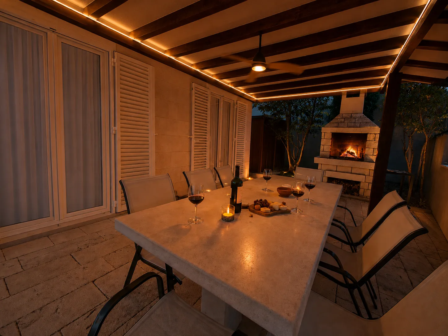 Lower terrace with outdoor fireplace at night